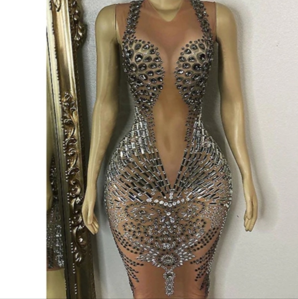 A custom handmade dress with stones. Nude see through.